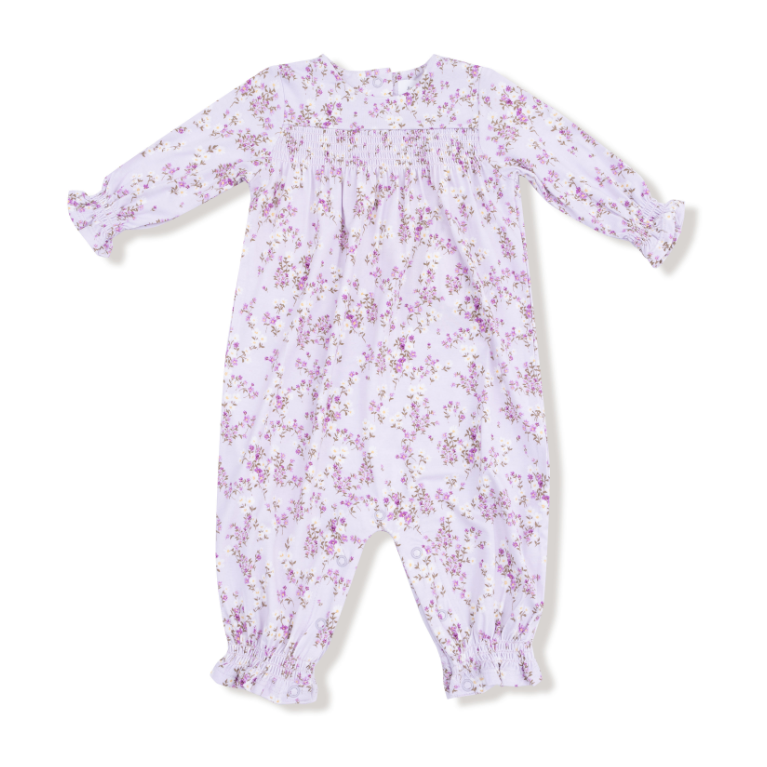 Floral patterned baby romper on a white background. Available at Be Charmed. 