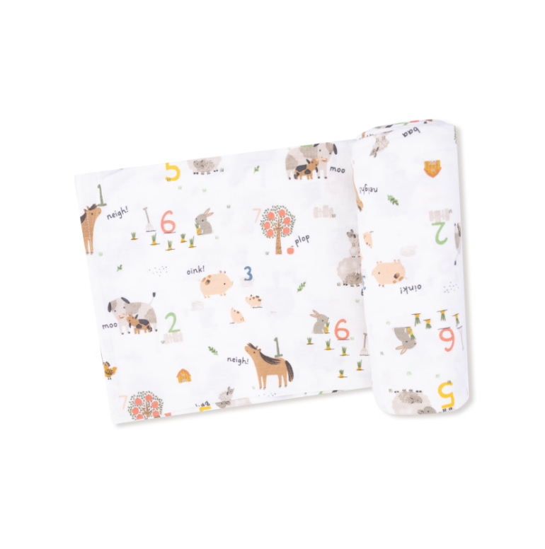 Baby blanket swaddle with farm animals and number pattern on a white background. Available at Be Charmed.  