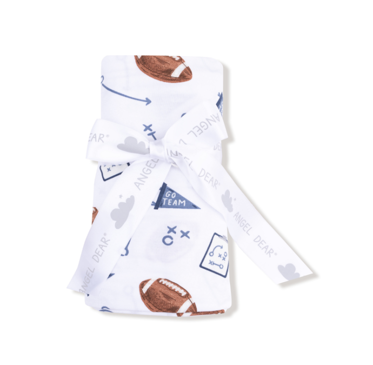 Baby blanket with sports-themed pattern on a white background. Available at Be Charmed. 
