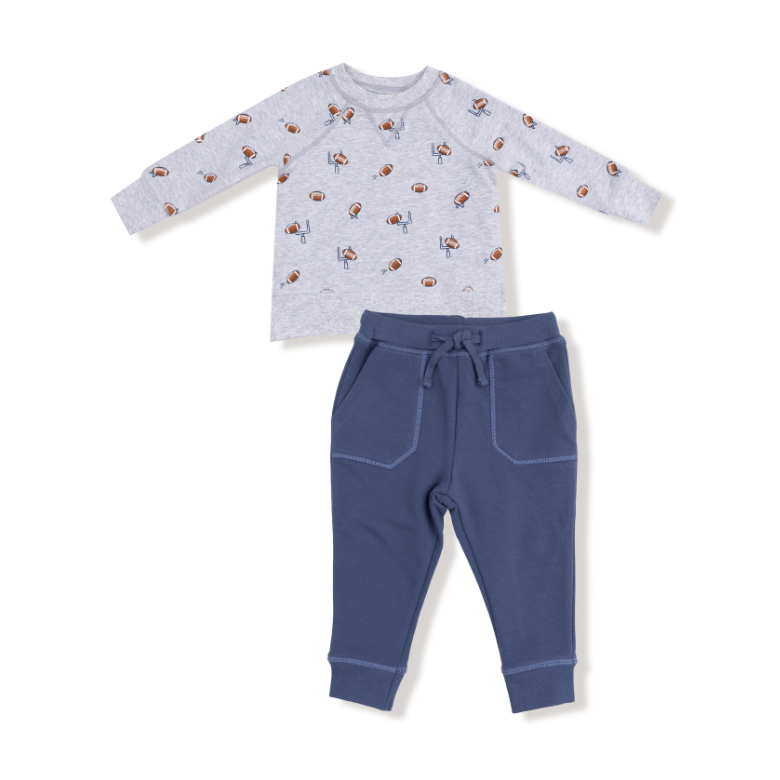 Baby football themed outfit with a long-sleeve shirt and pants on a white background. Available at Be Charmed. 