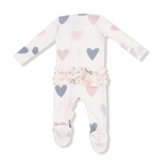 Baby onesie with heart patterns on a white background. Available at Be Charmed. 