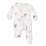 Baby onesie with heart pattern on a white background. Available at Be Charmed. 