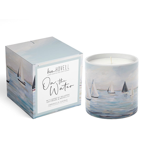 Annapolis Candle – Kim Hovell On The Water boxed candle featuring tranquil blue artwork and a fresh aquatic scent. Ideal for coastal décor or gifting. Available at Be Charmed.