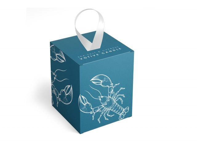Annapolis Candle Sea Salt & Cypress Lobster Decorative Votive featuring a 2oz soy wax candle with a coastal scent, housed in a decorative box with a white satin ribbon, available at Be Charmed