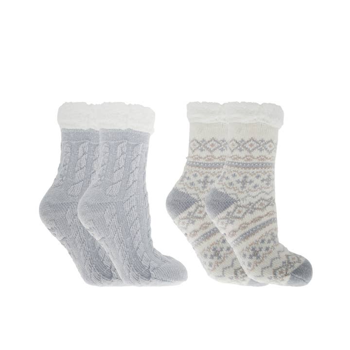 Two pairs of socks, one gray with cable knit pattern and white cuff, the other white with patterned design and gray cuff, on a white background. Available at Be Charmed. 