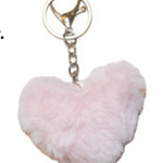 Heart-shaped pink fluffy keychain on a white background. Keychain comes with socks. 