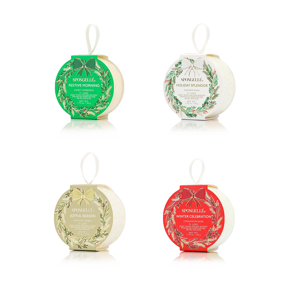 Four decorative bath bombs with festive labels on a white background. Available at Be Charmed