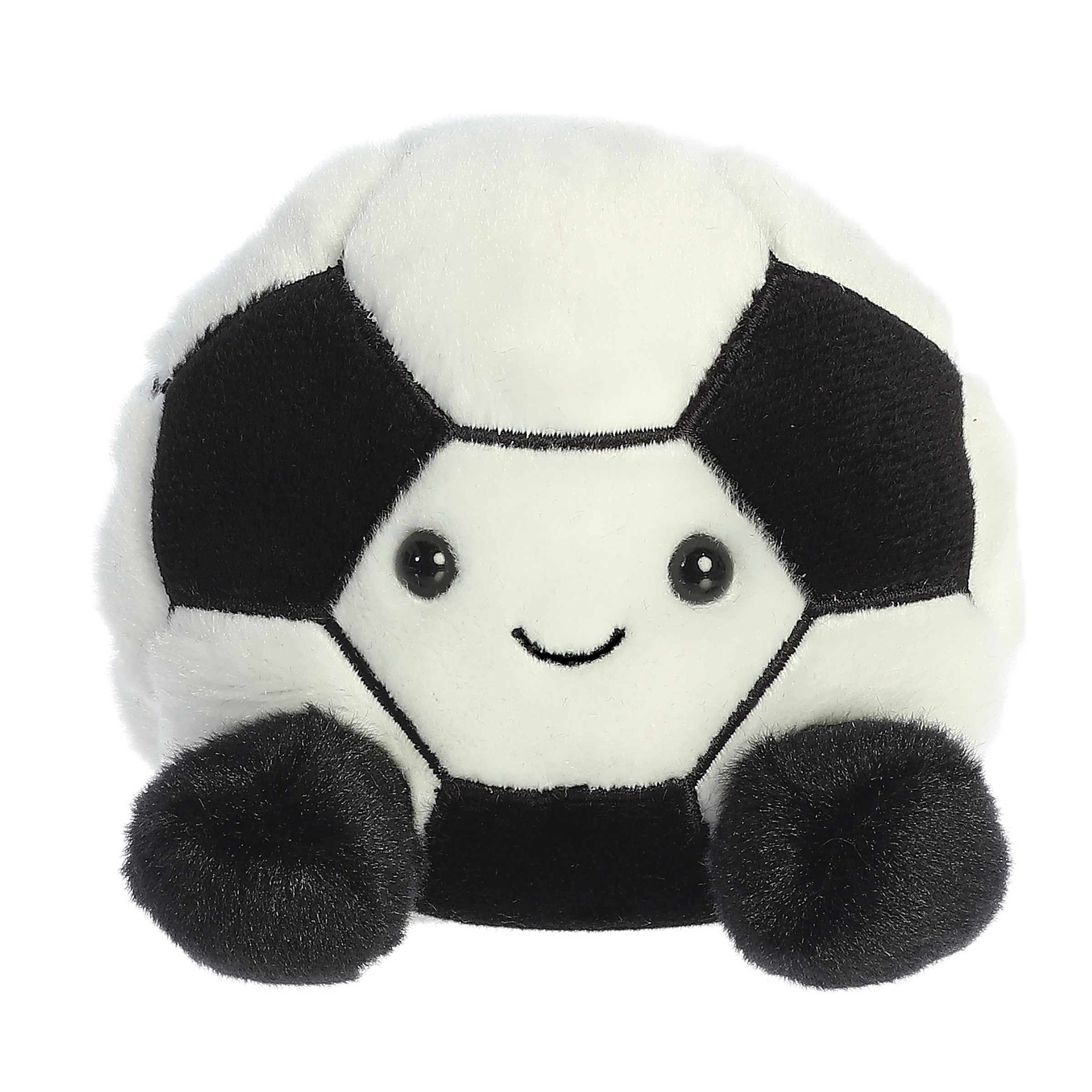 Aurora Palm Pal Striker Soccerball 5-inch plush toy with soft black and white fabric panels, embroidered smile, and bean-filled body. Available at Be Charmed.