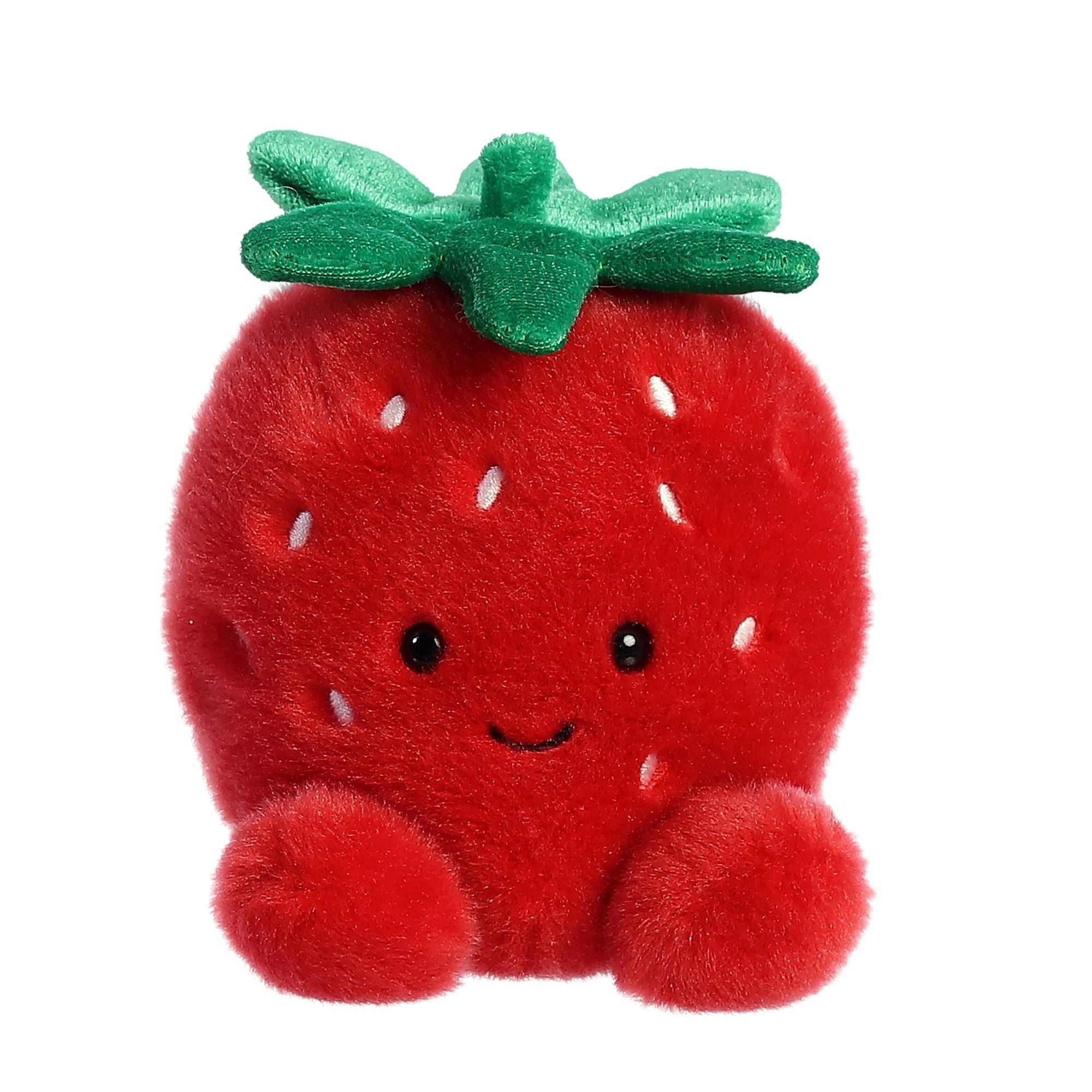 Aurora Palm Pal Juicy Strawberry plush, 5-inch red fruit toy with green leaf top, embroidered smile, and soft bean-filled body. Available at Be Charmed.