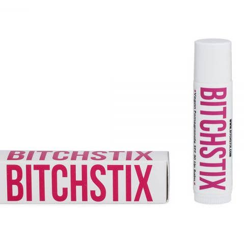 BITCHSTIX pomegranate lip balm and packaging on a white background. Available at Be Charmed