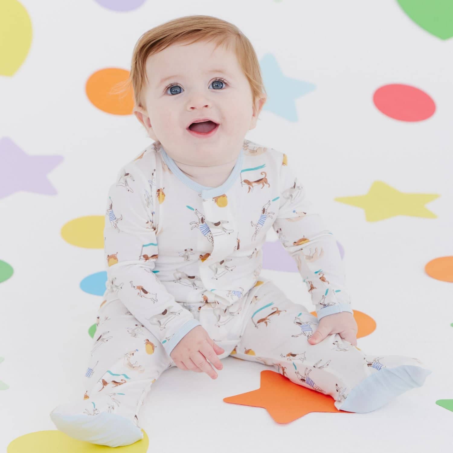 Baby wearing a Magnetic Me footie in Howlarious print, available at Be Charmed.