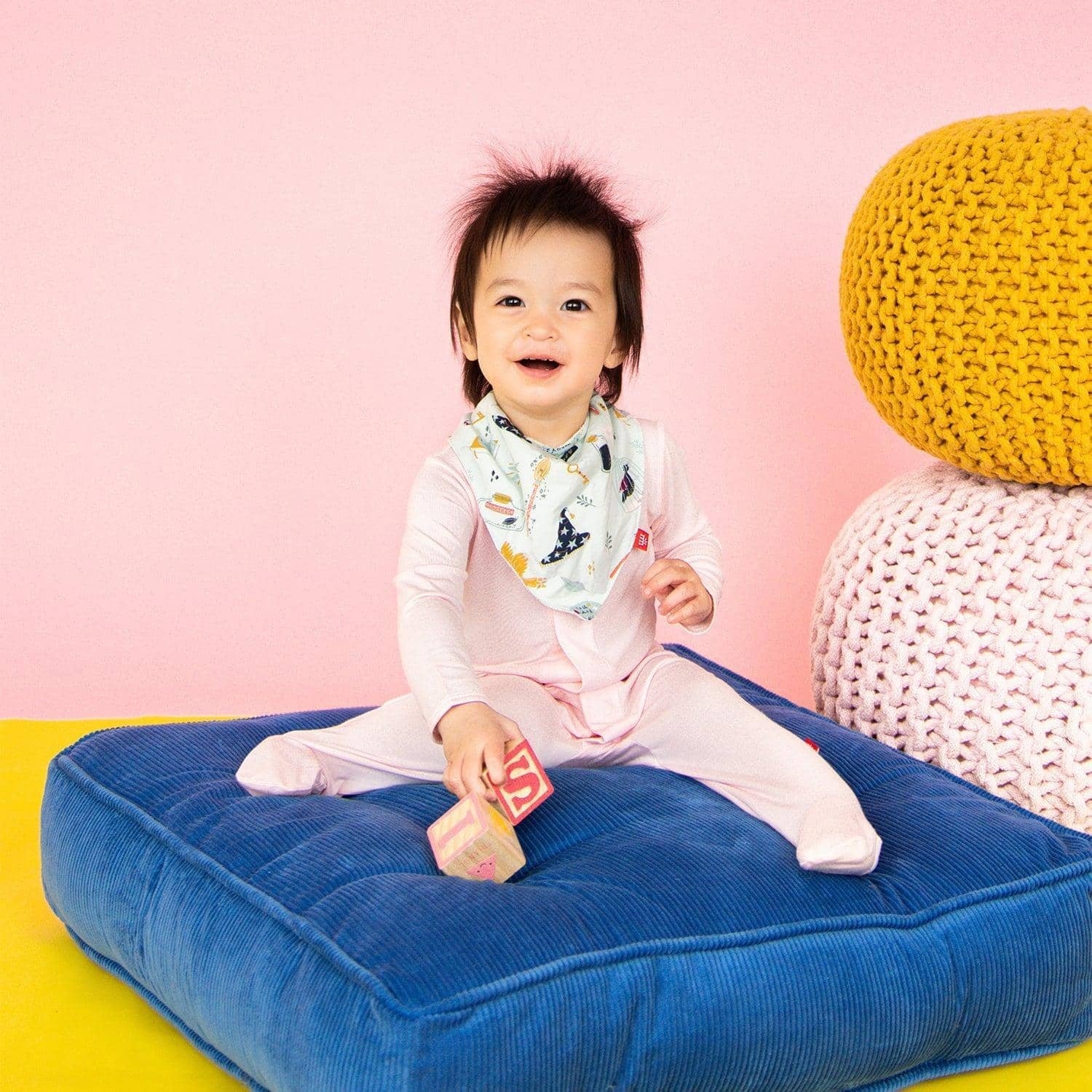 Baby wearing a Magnetic Me modal footie in Pink Dogwood, available at Be Charmed.