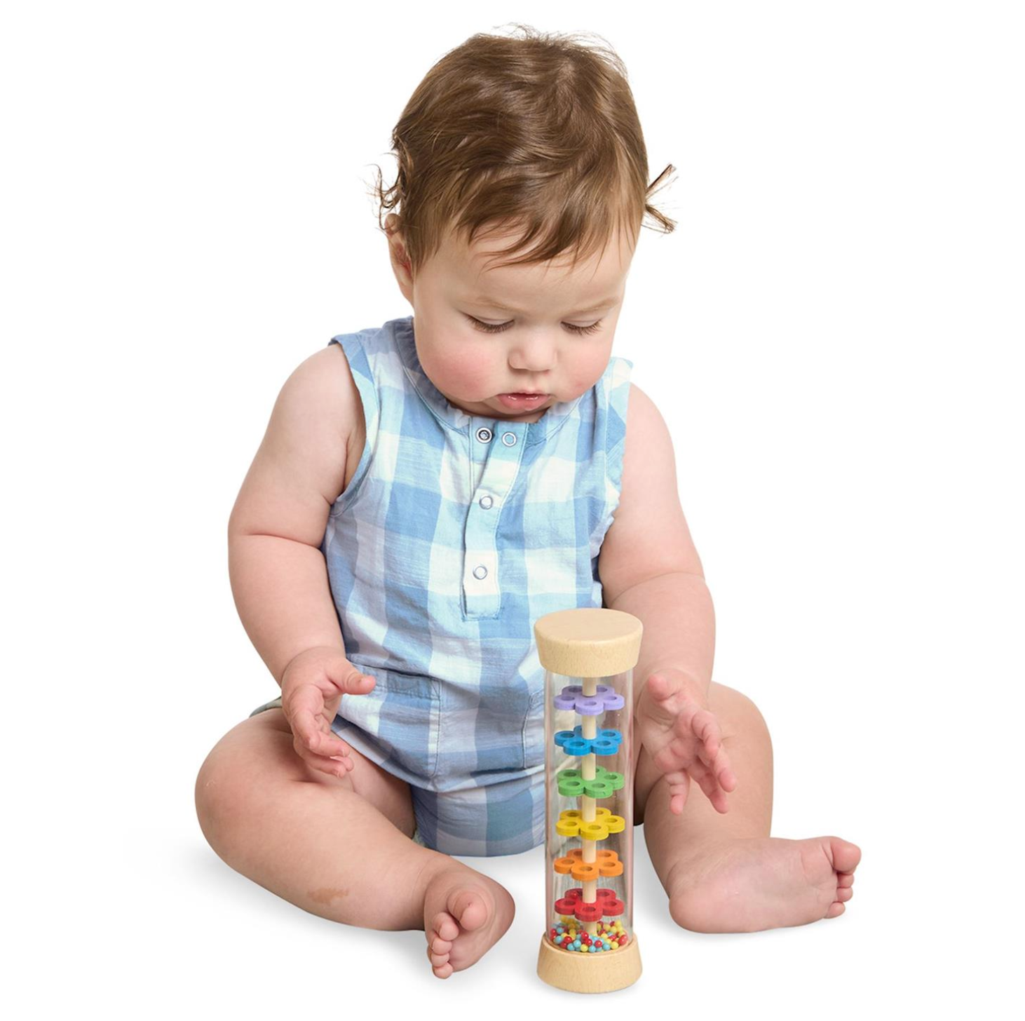 Child playing with a colorful wooden toy rattle on a white background. Available at Be Charmed