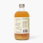 Bottle of liquid with a label on a white background. Available at Be Charmed