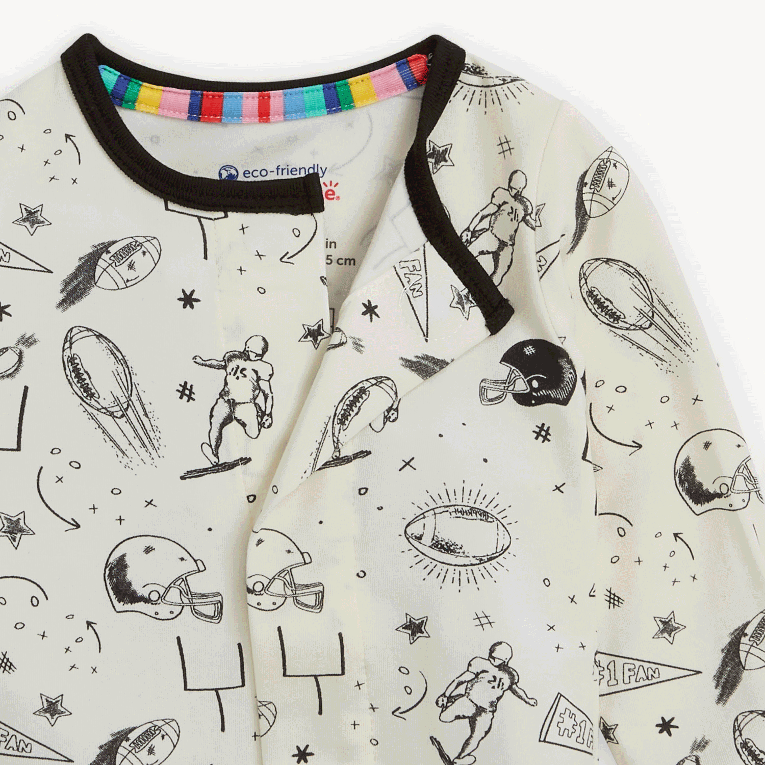 Back view of Magnetic Me baby footie in Natural Game Day print with sports icons. Soft modal fabric with magnetic closures for easy dressing. Available at Be Charmed.