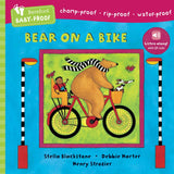 Book cover of 'Bear on a Bike' with colorful illustration of a bear riding a bike. Available at Be Charmed