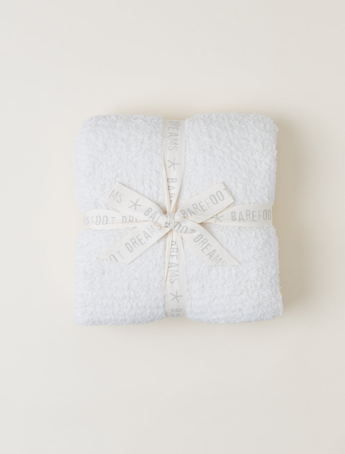 Cream Barefoot Dreams CozyChic Throw in neutral tone, ultra-soft microfiber knit, 54×72″, available at Be Charmed.