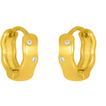 A pair of gold-colored huggie earrings with sparkling cubic zirconia set within. Available at Be Charmed