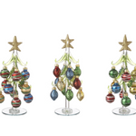 An 8-inch hand-blown Ganz glass Christmas tree with colorful miniature ornaments and a mirrored base. Available at Be Charmed