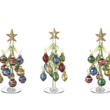 An 8-inch hand-blown Ganz glass Christmas tree with colorful miniature ornaments and a mirrored base. Available at Be Charmed