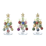 Three decorative Christmas trees with colorful ornaments on a white background. Available at Be Charmed