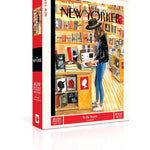 New York Puzzle Co At The Strand 1000 piece jigsaw puzzle featuring an illustrated bookstore scene available at Be Charmed