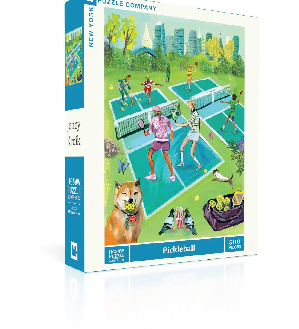 New York Puzzle Co Pickleball 500 piece jigsaw puzzle featuring a vibrant city park illustration by Jenny Kroik available at Be Charmed