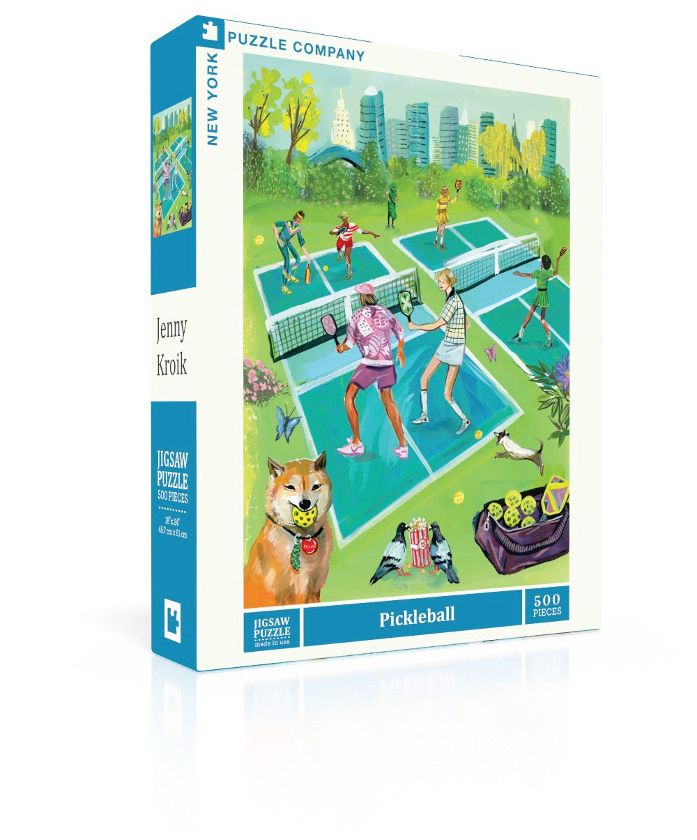 New York Puzzle Co Pickleball 500 piece jigsaw puzzle featuring a vibrant city park illustration by Jenny Kroik available at Be Charmed