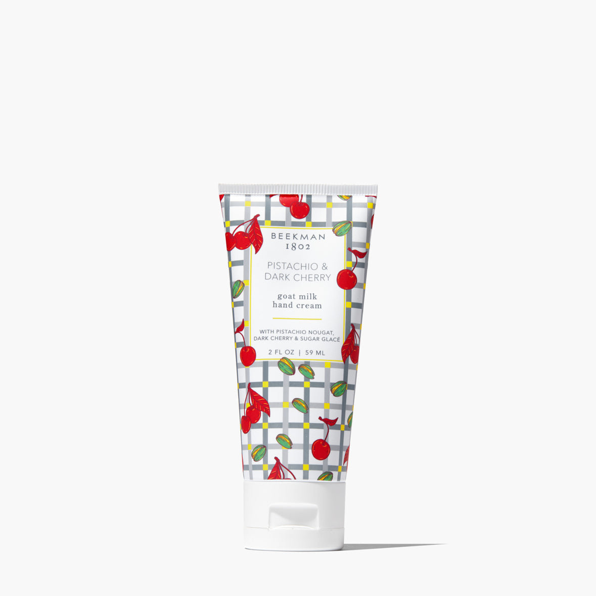 Hand cream tube with cherry design on a white background. Available at Be Charmed