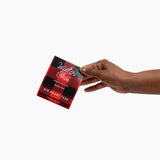 Hand holding a 'Winter Chai' tea package against a white background.  Available at Be Charmed