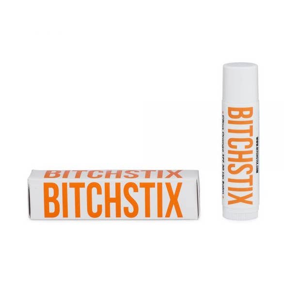 Citrus Orange Bitchstix lip balm with packaging on a white background. Available at Be Charmed