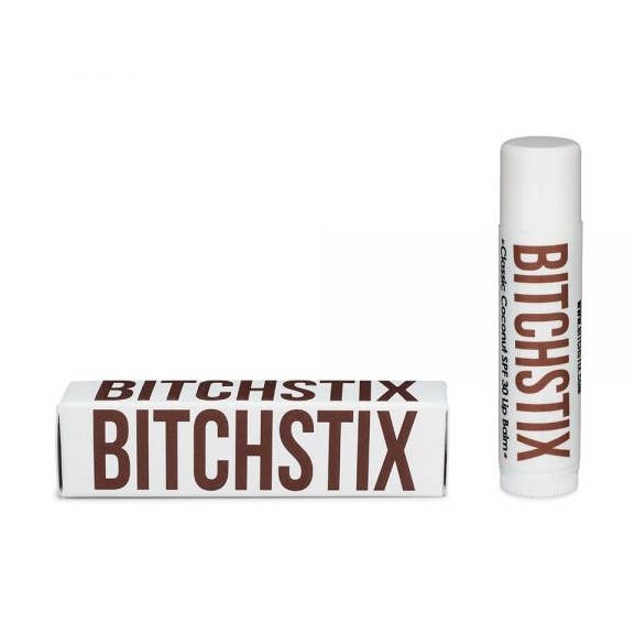Classic Coconut Bitchstix lip balm and packaging on a white background. Available at Be Charmed