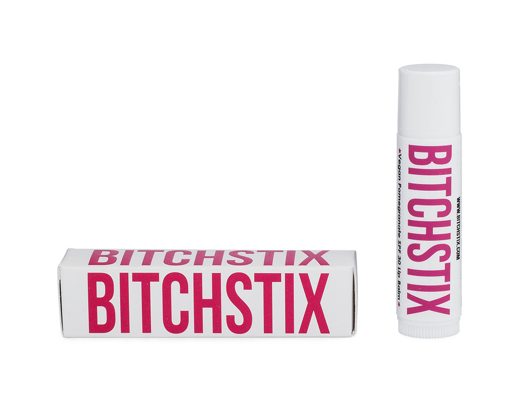 Pomegranate Bitchstix lip balm and packaging on a white background. Available at Be Charmed