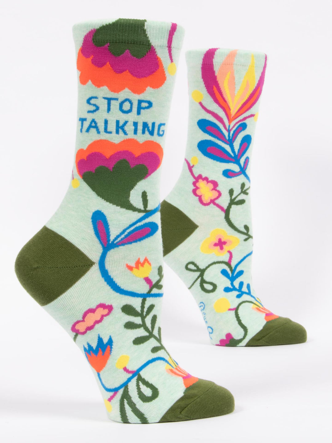 Colorful socks with floral designs and text on a light green background. Available at Be Charmed