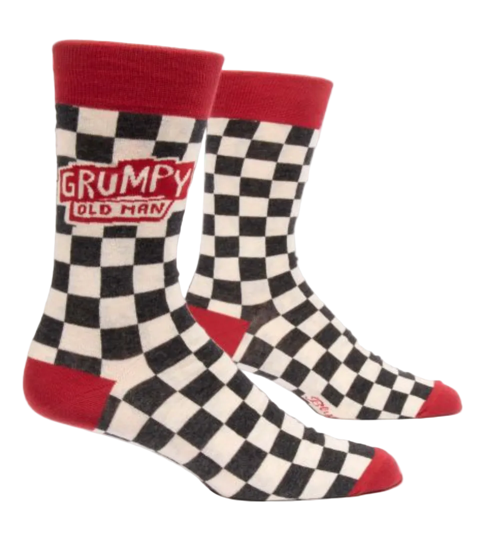 A pair of men's crew socks with a checkered pattern, featuring the text 'GRUMPY OLD MAN' on the ankle area. Available at Be Charmed