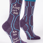 A pair of purple crew socks with blue q branding and the text 'I love my job' printed on the side, displayed against a white background. Available at Be Charmed