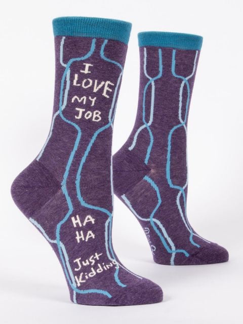A pair of purple crew socks with blue q branding and the text 'I love my job' printed on the side, displayed against a white background. Available at Be Charmed