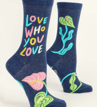 Blue Q "Love Who You Love" Crew Socks featuring a colorful design and positive message, available at Be Charmed.