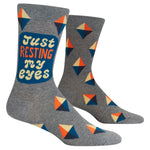 Gray socks with geometric pattern and 'Just Resting My Eyes' text on a white background. Available at Be Charmed