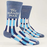 A pair of men's crew socks with blue and white stripes and 'The Handyman' text on the ankle area. Available at Be Charmed