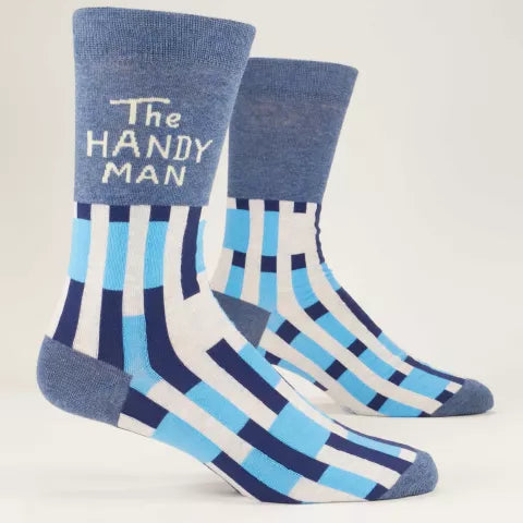 A pair of men's crew socks with blue and white stripes and 'The Handyman' text on the ankle area. Available at Be Charmed