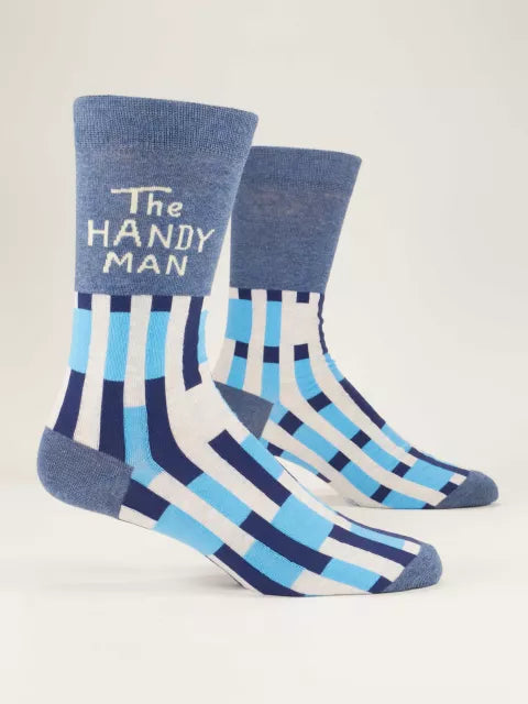 A pair of men's crew socks with blue and white stripes and 'The Handyman' text on the ankle area. Available at Be Charmed
