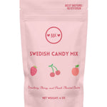 Pink package of Swedish candy mix with BBK branding on a white background. Available at Be Charmed