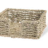 Woven basket made of natural fibers on a white background. Available at Be Charmed