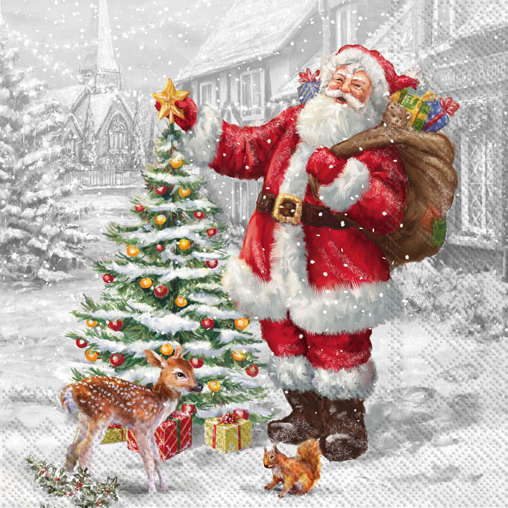 Santa Claus with a sack of gifts standing next to a decorated Christmas tree in a snowy village setting paper cocktail napkins. Available at Be Charmed.