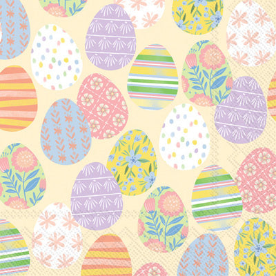 Boston International Eggstra Eggs cream cocktail napkins featuring pastel decorated Easter eggs on 3‑ply paper, available at Be Charmed.