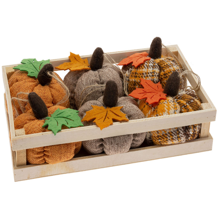 Decorative pumpkins with leaves in a wooden crate on a white background. Available at Be Charmed