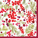 A cocktail napkin with a Christmas-themed design featuring red and green berries and holly leaves on a white background. Be Charmed