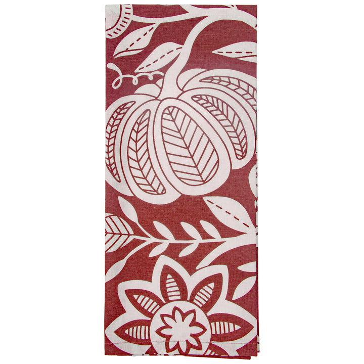 Red towel with white floral and leaf patterns on a white background. Available at Be Charmed