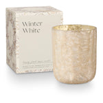 Candle with decorative box labeled 'Winter White' on a white background. Available at Be Charmed